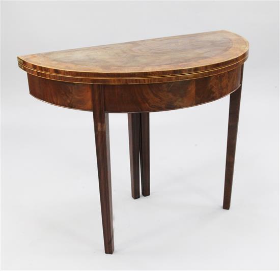 A George III mahogany, satinwood and rosewood banded demi lune folding card table, W.3ft 1in.